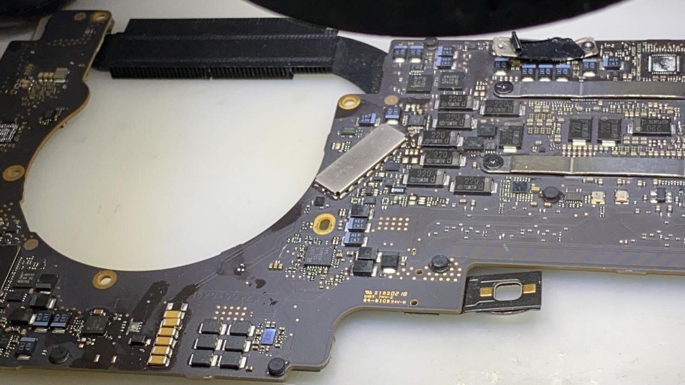 Close-up of a MacBook logic board removed for repair